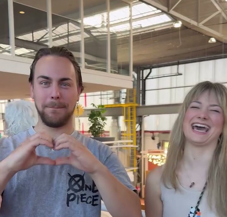 Students making heart hands together at a Guaranteed Prosperity seminar